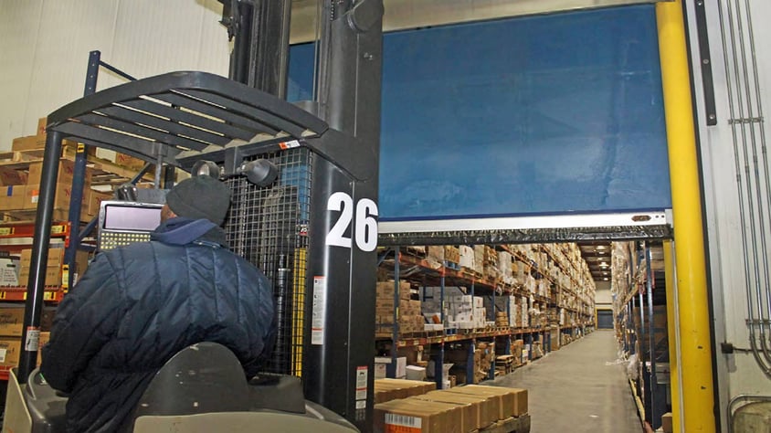 Open Turbo Seal door behind man using forklift