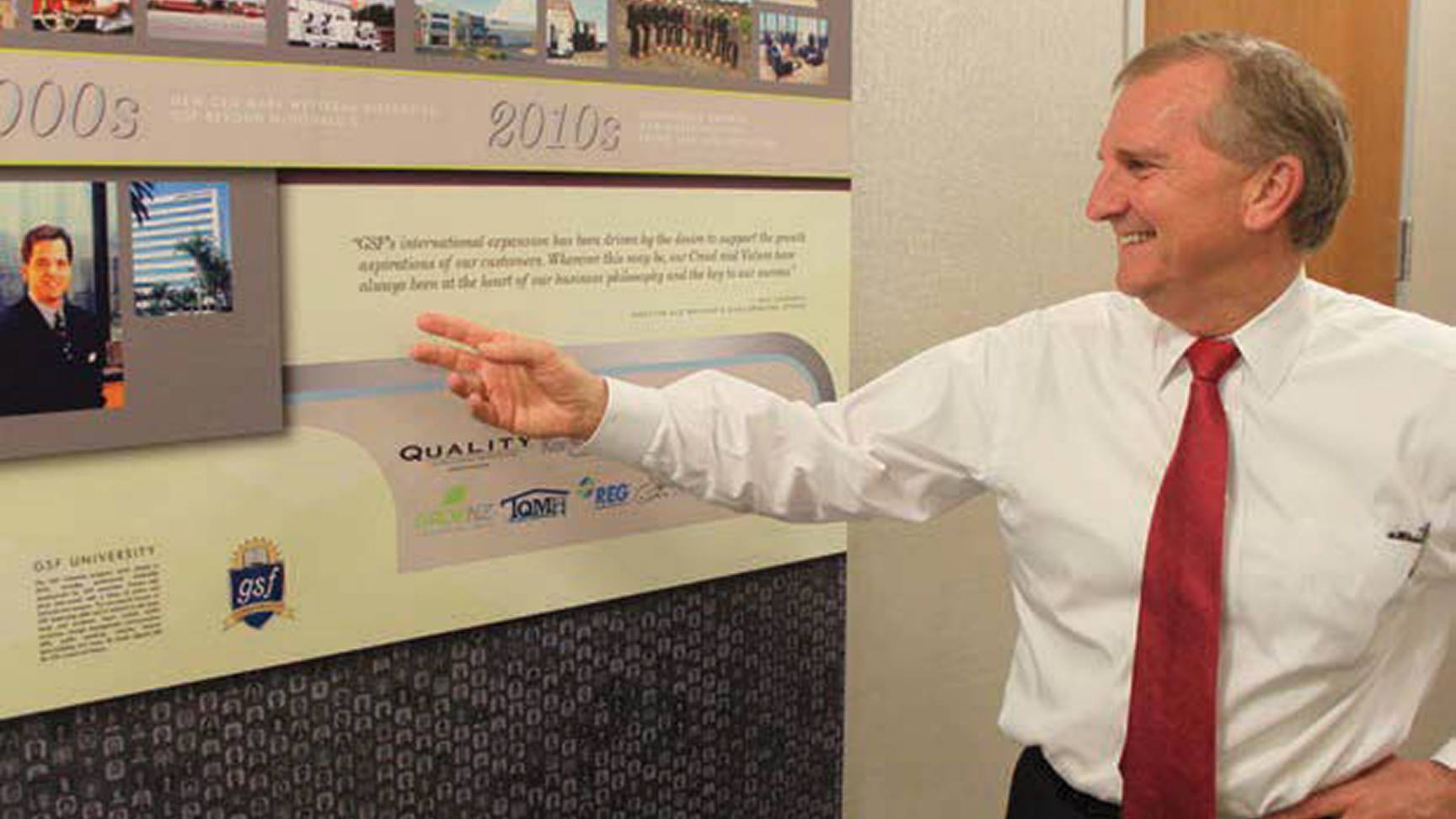 man in tie pointing at GSF history timeline