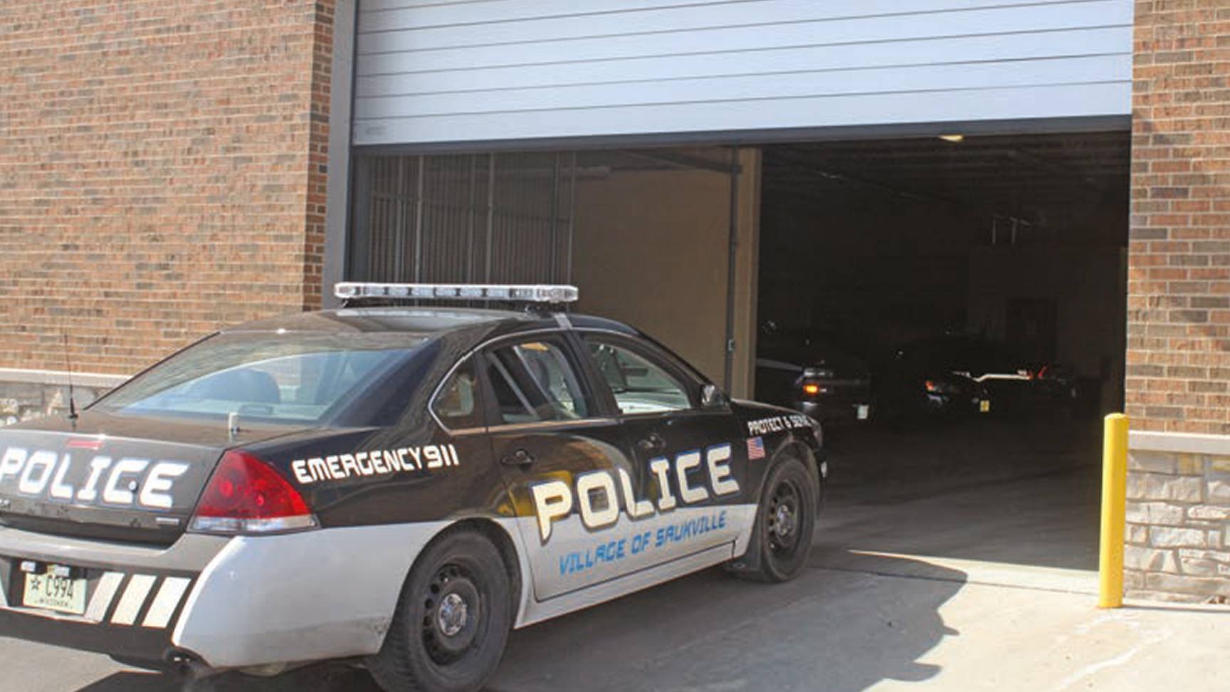 Rytec Spiral Door opening with police car coming in building-outside view