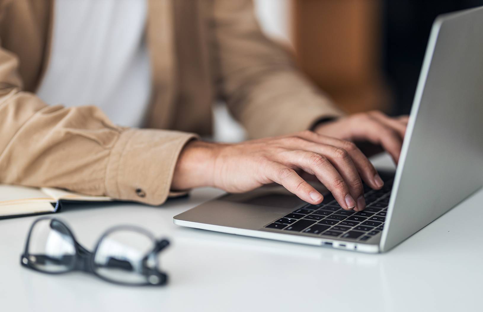 close up of man typing on laptop