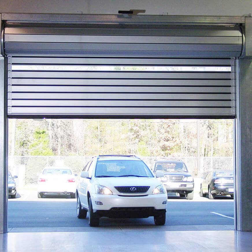Lexus vehicle driving through open dealership bay door