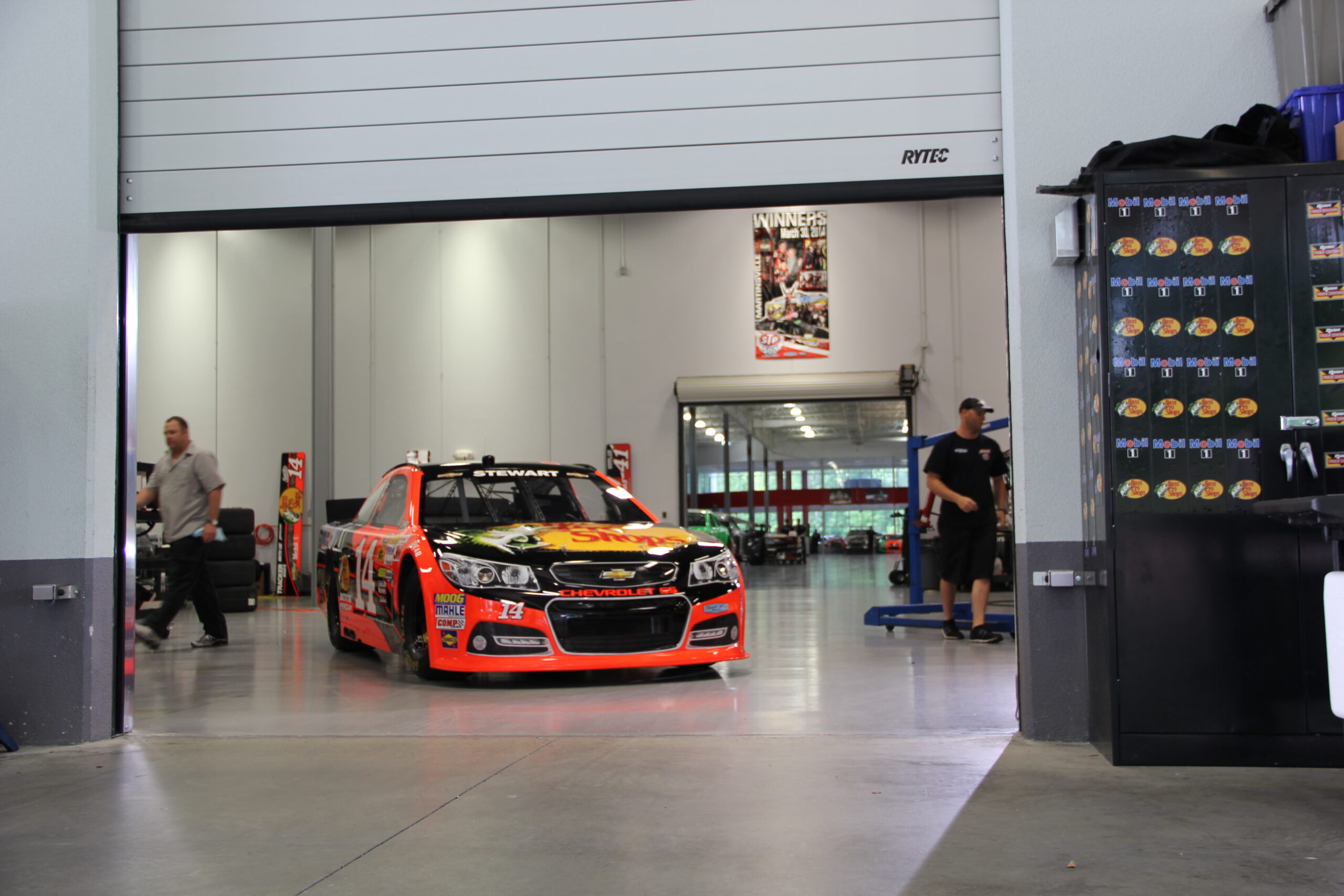 racecar parked in garage behind a Rytec door