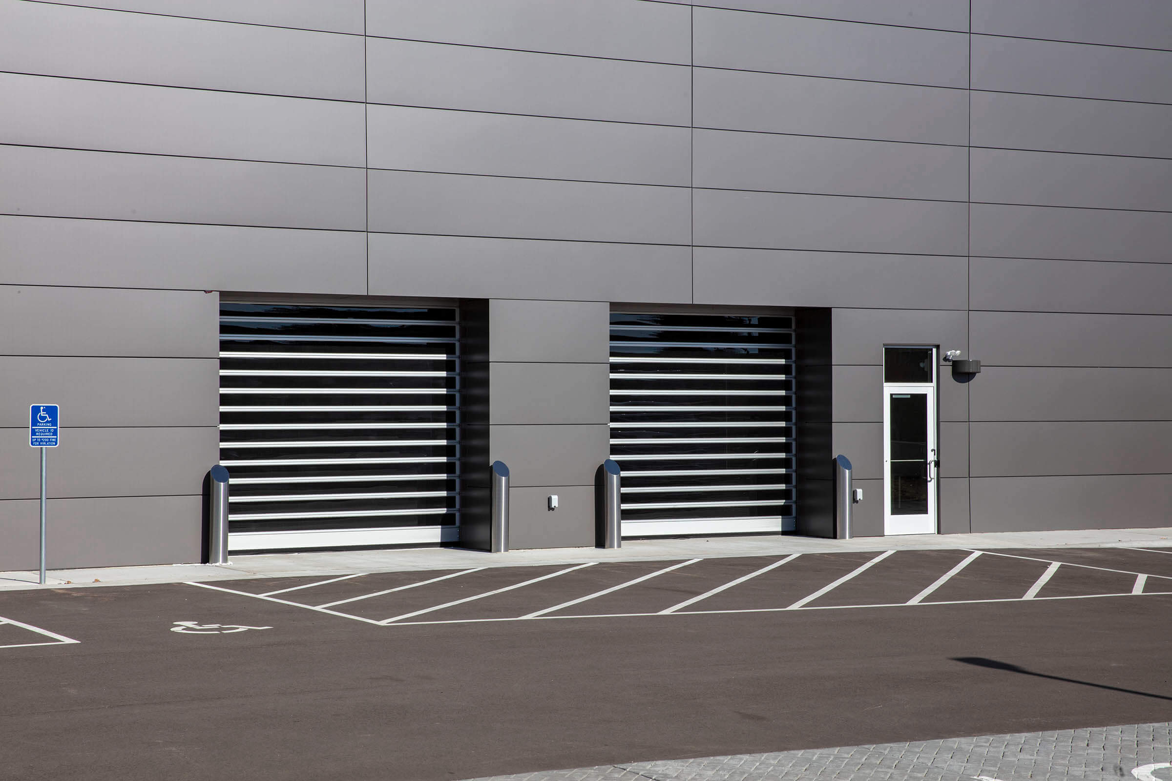 Spiral FV high speed doors on gray auto dealership building