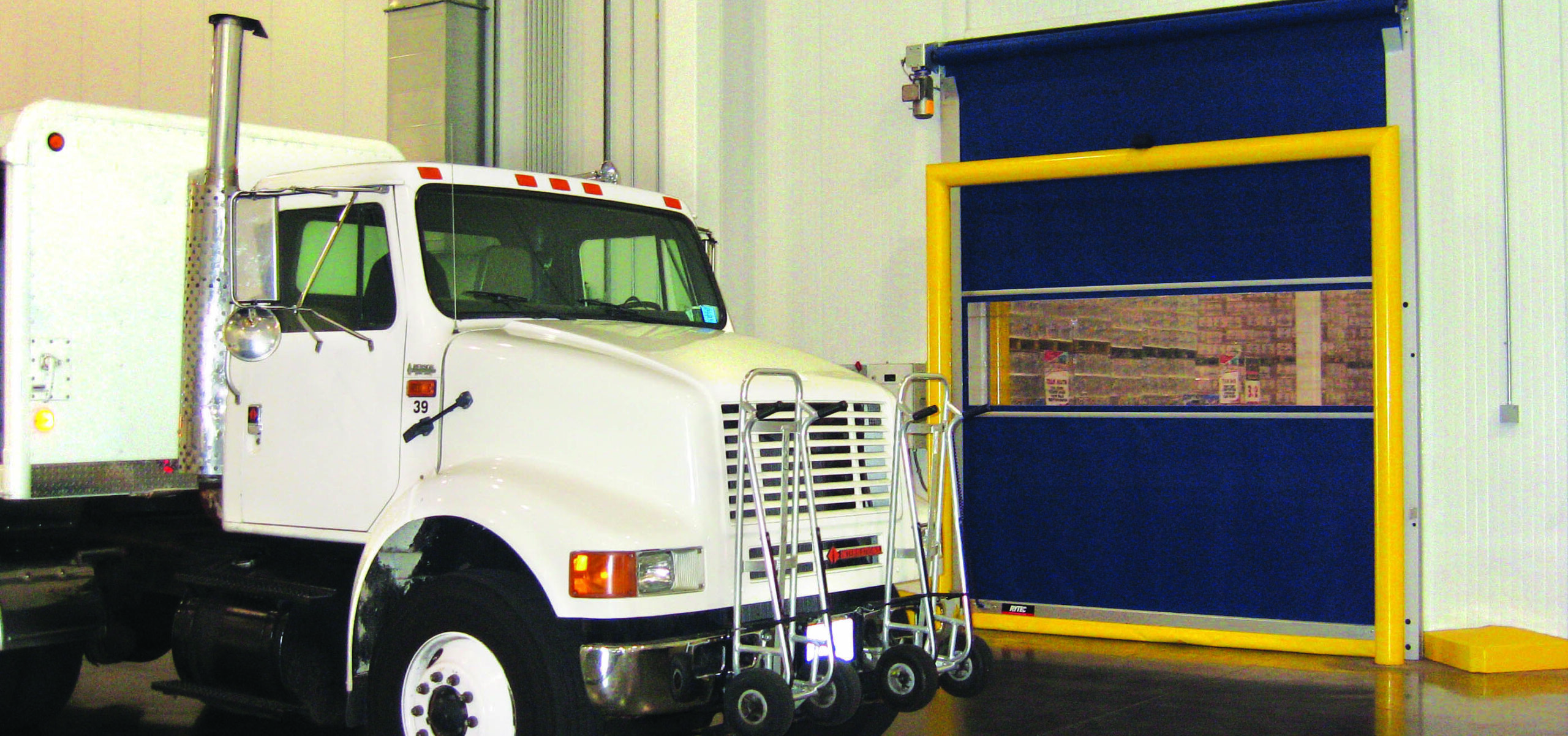 white truck in front of Predadoor roll up warehouse door