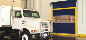 white truck sitting in front of Predadoor fabric warehouse door