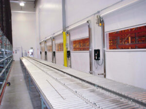 Pharma Roll fabric doors along a warehouse roller conveyor