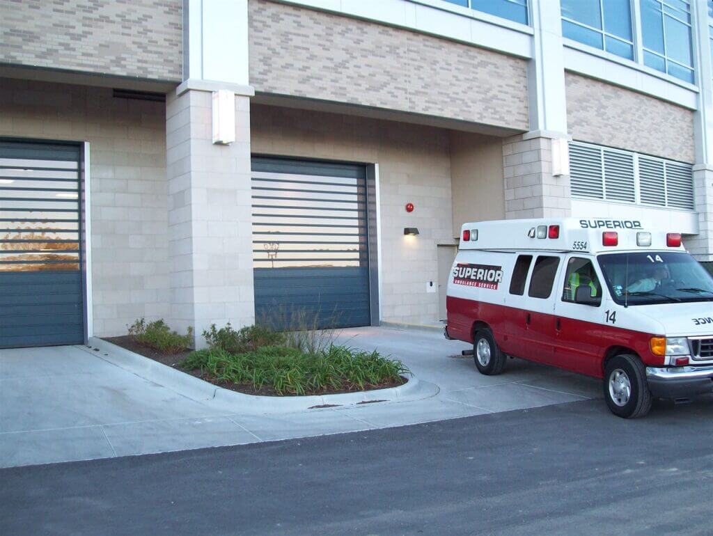 ambulance sitting outside of hospital parking garage door