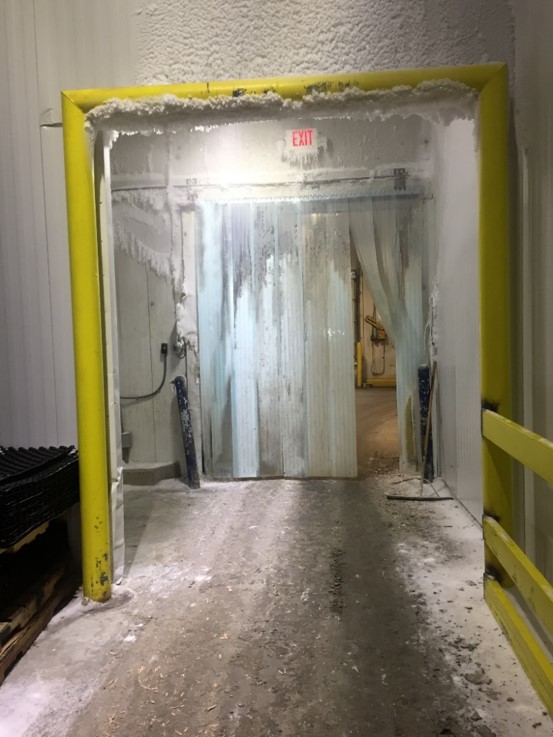 old door losing heat in cold storage facility